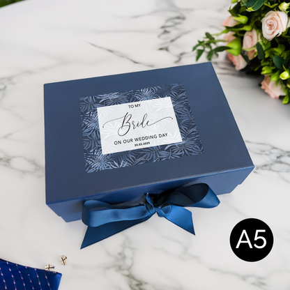 a blue box with a blue bow on a table